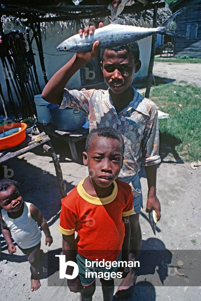 Boy with fish in village on Mosquito Coast, Honduras (photo)