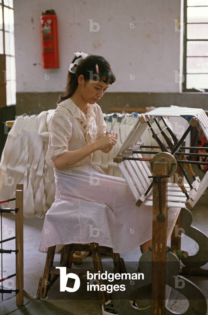Silk after having been washed is wound onto spools during the Chinese silk process at the Hangzhou Silk Company factory, Hangzhou, Zhejiang Province, China (photo)