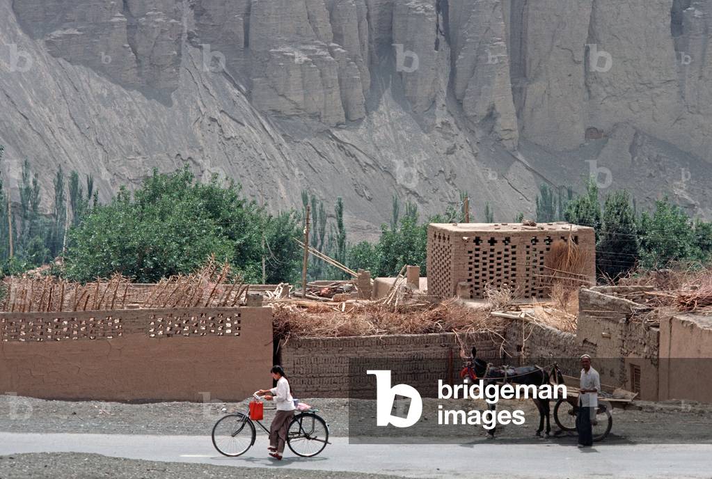 Grape storehouses made out of mud with gaps in bricks to air dry grapes in wine growing area around Turpan, Xinjiang Province, China, 1985 (photo)