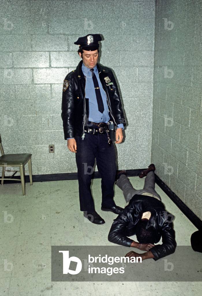 Harlem, African American in custody in 28th Precinct police station, New York City, 1978 (photo)