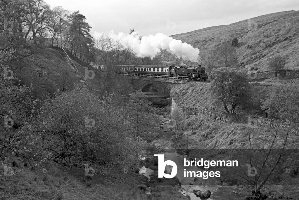 North Yorkshire Moors Railway steam trai crossing River Esk in the Esk Valley, North Yorkshire, England, UK, 1992 (b/w photo)