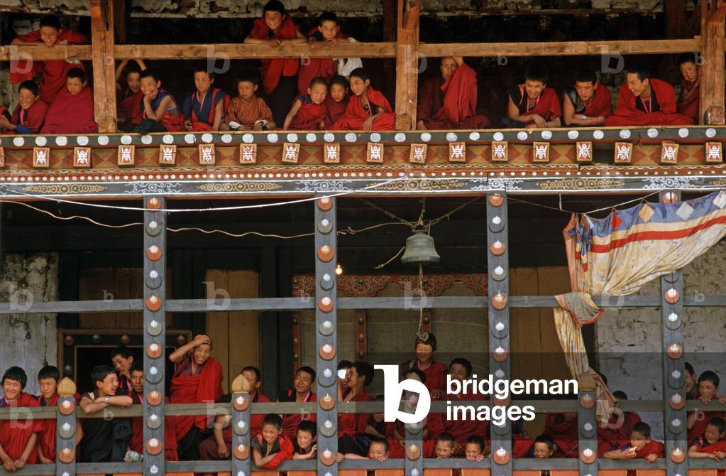 Buddhist monks watching the Paro Tshechu, mask dance festival, in the Paro Dzong, Bhutan   (photo)