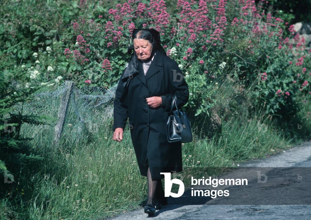 Breton lady on way to Sunday Mass, Island of Ushant, Brittany, France (photo)