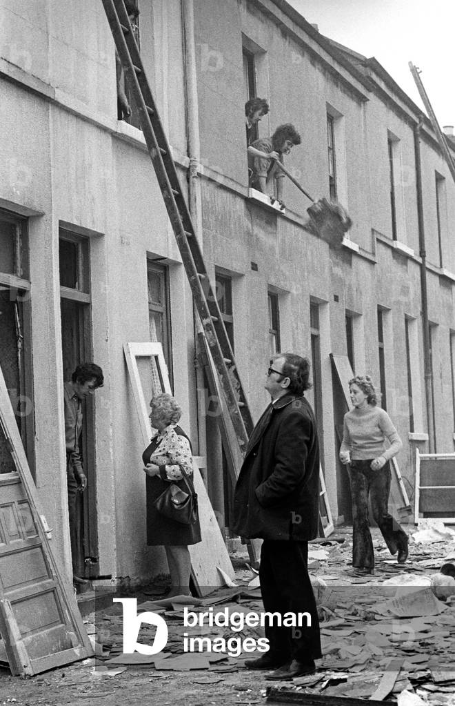 Clearing up after IRA bomb damage in the Shankill Loyalist area of Belfast in the early 70s, Northern Ireland during The Troubles, 1974 (b/w photo)