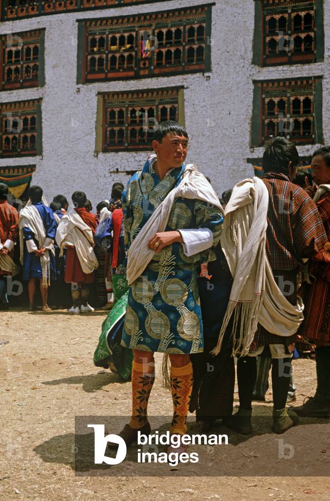 Bhutanese man in traditional costumes at the Paro Tshechu, mask dance festival, in the Paro Dzong, Bhutan (photo)