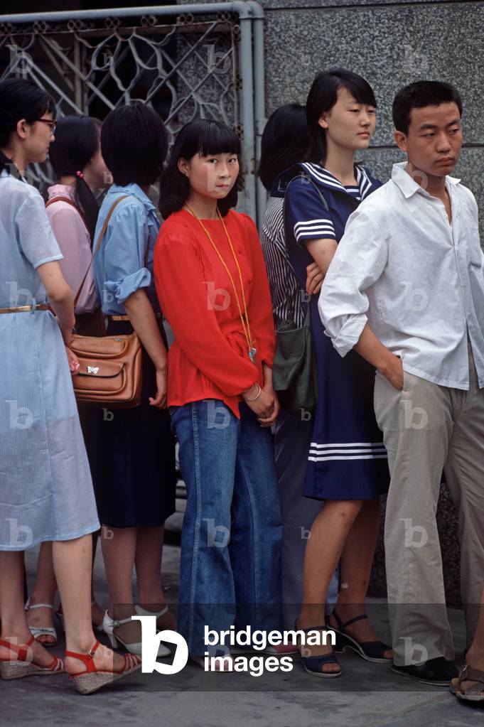 Young Chinese girl in employment queue for smart new Beijing shop, Beijing (photo)