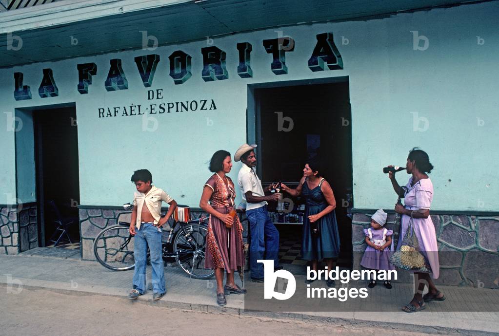 People drinking outside bar in rural honduras (photo)