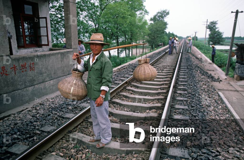 Water carrier for railway track repair gang in Zhejiang Province, China (photo)
