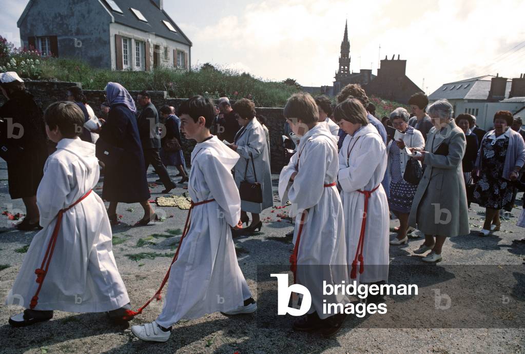 Alter boys in Roman Catholic Holy day procession in village of Lampaul, Island of Ushant, Brittany, France (photo)