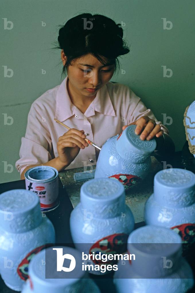 Chinese girl hand painting rice wine jars, Shaoxing Rice Wine factory, Shaoxing, China (photo)