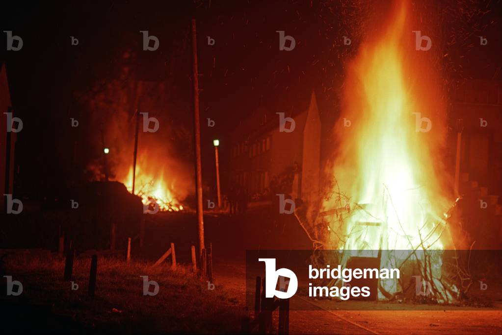 Bonfires lit for Internment anniversary in Ballymurphy, a Republican area of West Belfast during The Troubles, Northern Ireland, 1972 (photo)