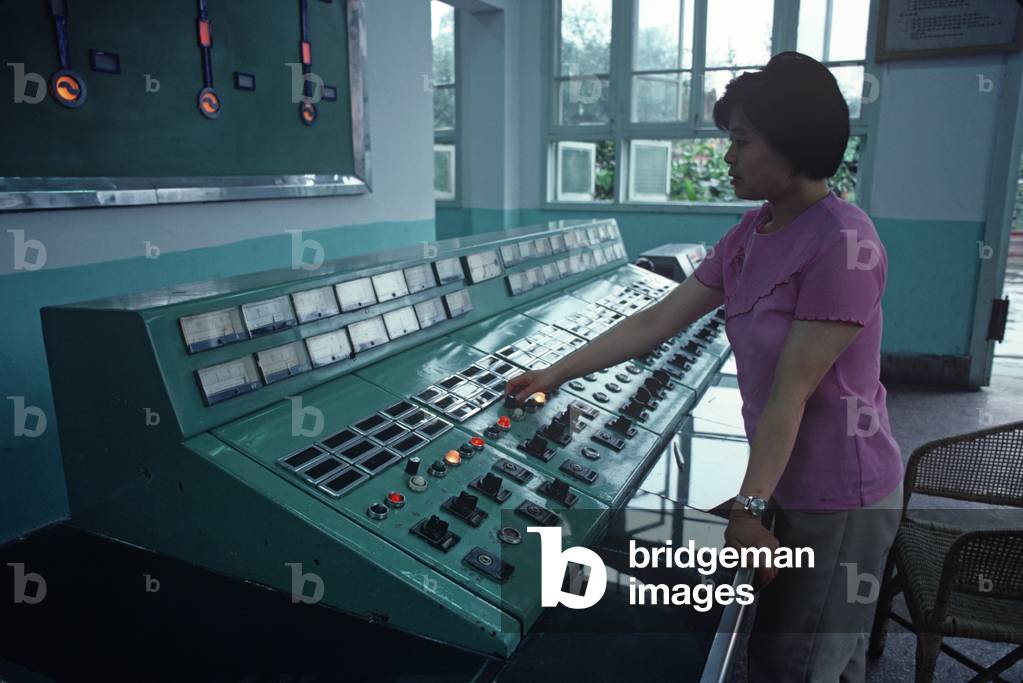 Chinese woman at control panel of Hydro electric plant in Chengdu, Sichuan Province, China (photo)