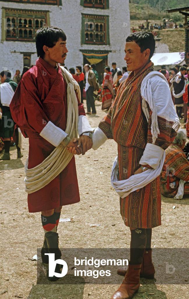 Bhutanese men in traditional costumes at the Paro Tshechu, mask dance festival, in the Paro Dzong, Bhutan (photo)