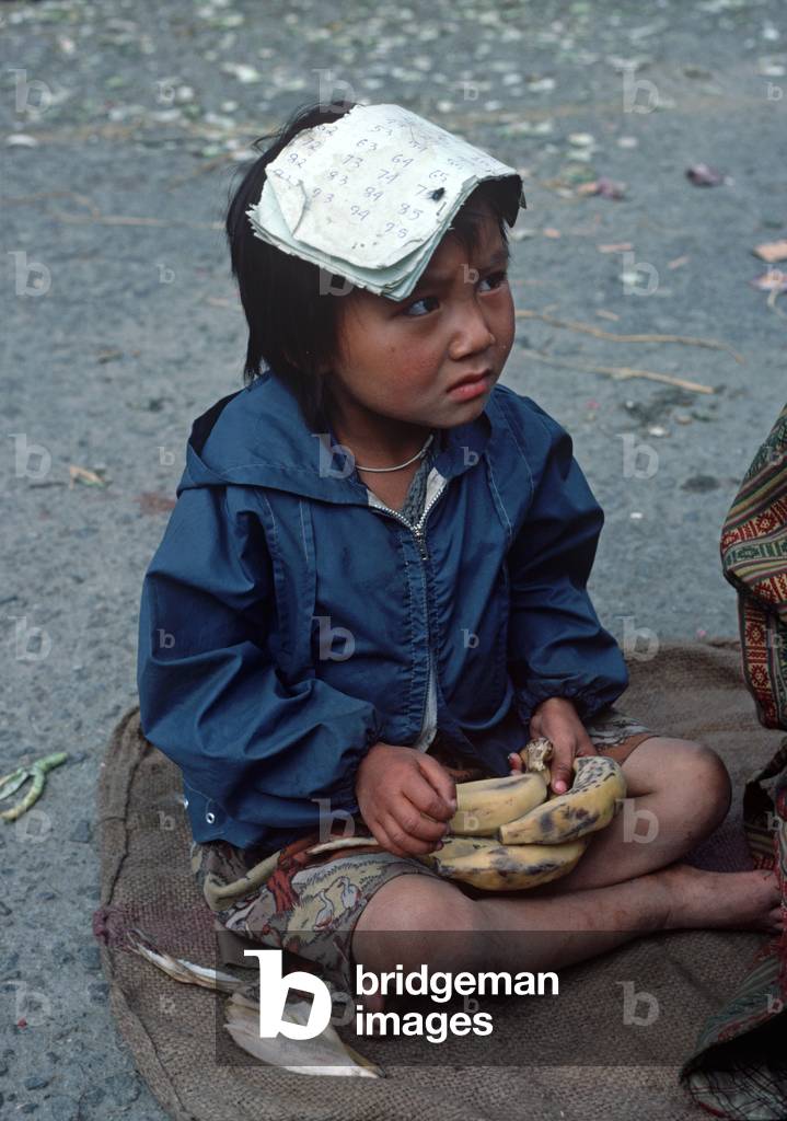 young Bhutanese girl selling bananas in Thimphu market, Bhutan, Himalayas (photo)