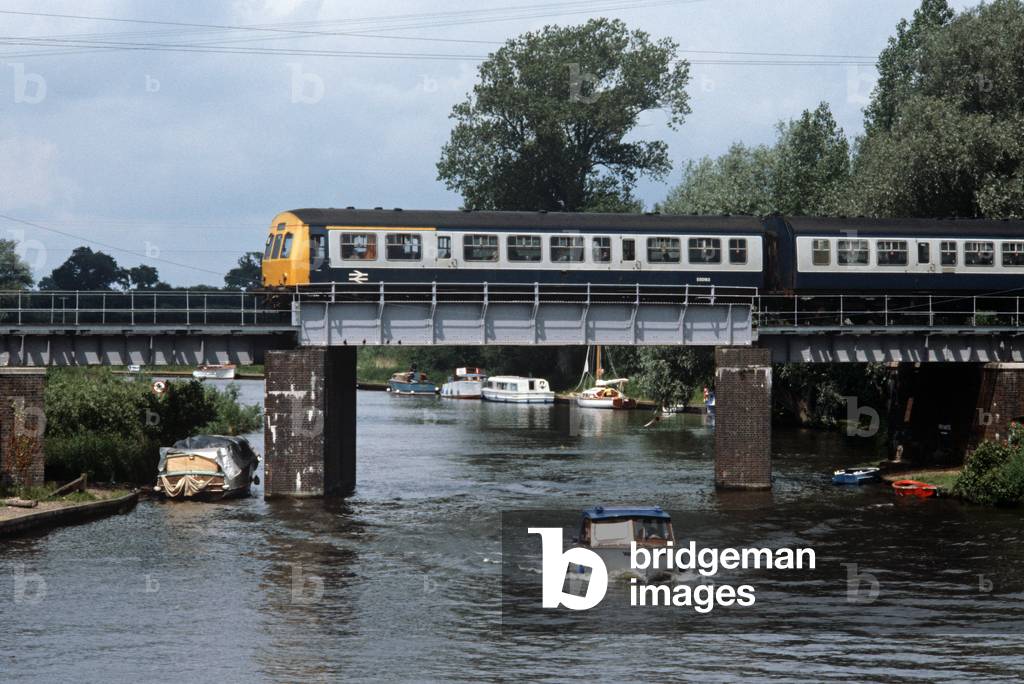 Diesel Multiple Unit train over the Norfolk Broads at Wroxham on the Norwich to Sheringham line, Norfolk, England, 1982 (photograph)