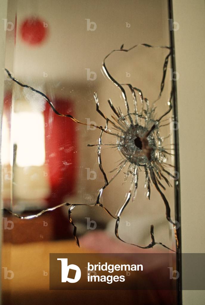 Bedroom wardrobe cracked mirror from bullet fired from IRA sniper during The Troubles, Northern Ireland, 1972 (photo)