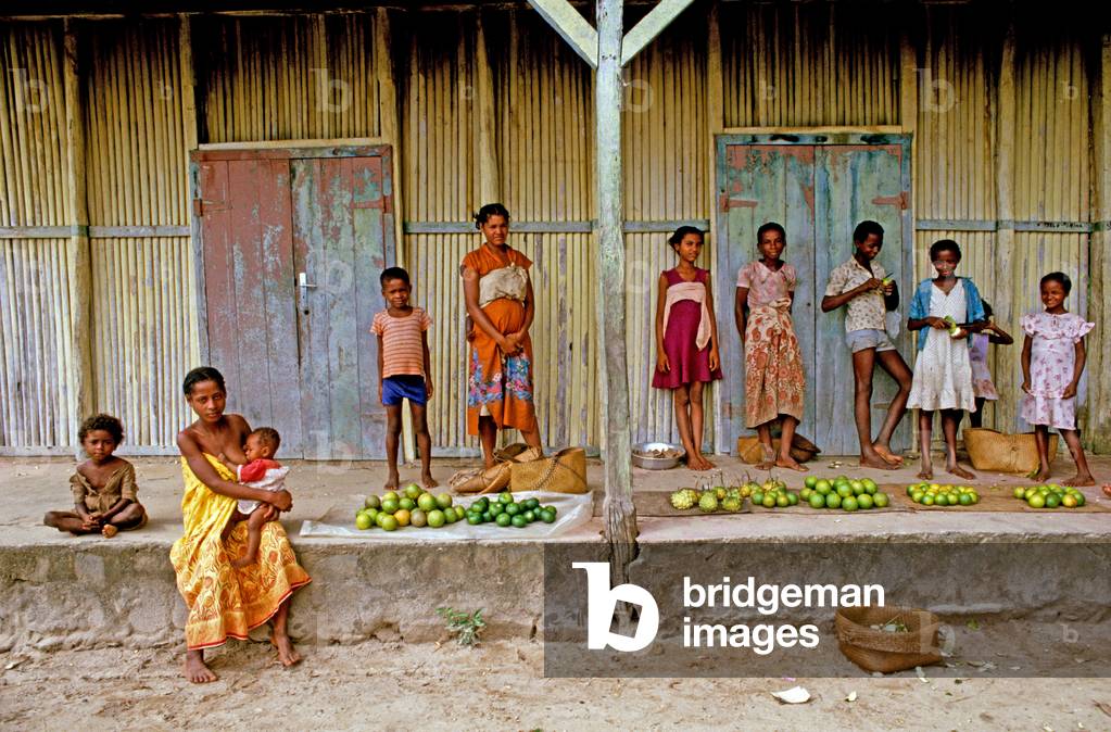 Mother breast feeding and children at Perinet market, Madagascar, East Africa, Africa, 1980s (photo)