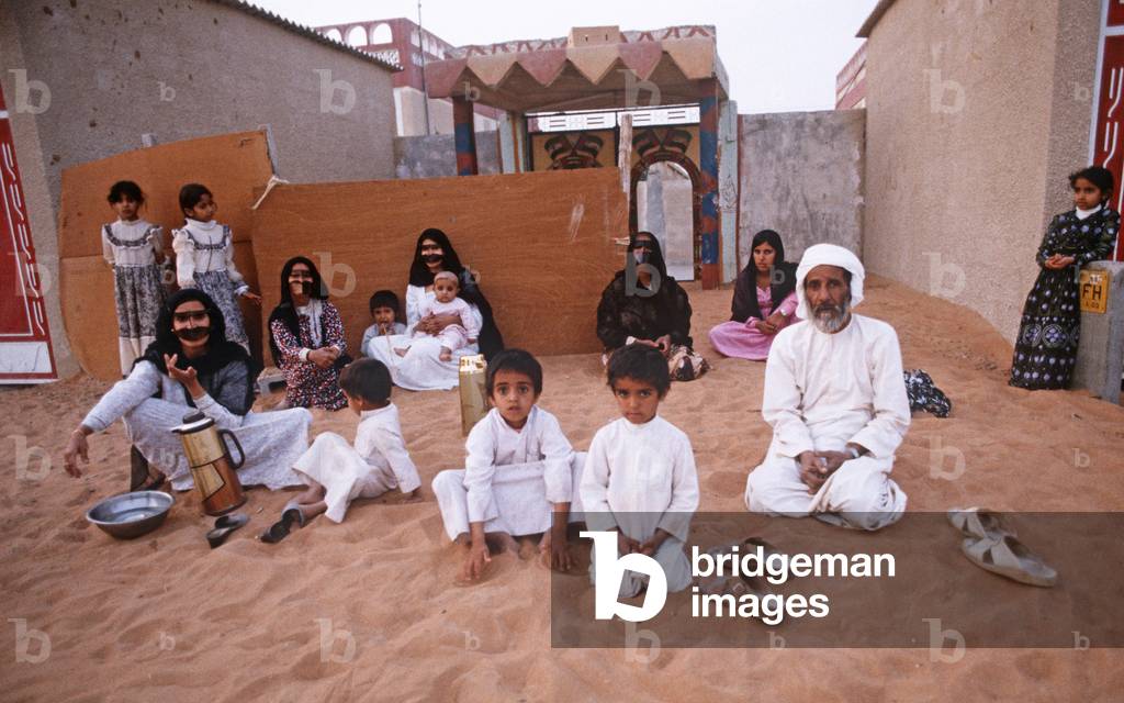 Traditional United Arab Emirate family out side house in Dubai suburb, UAE
