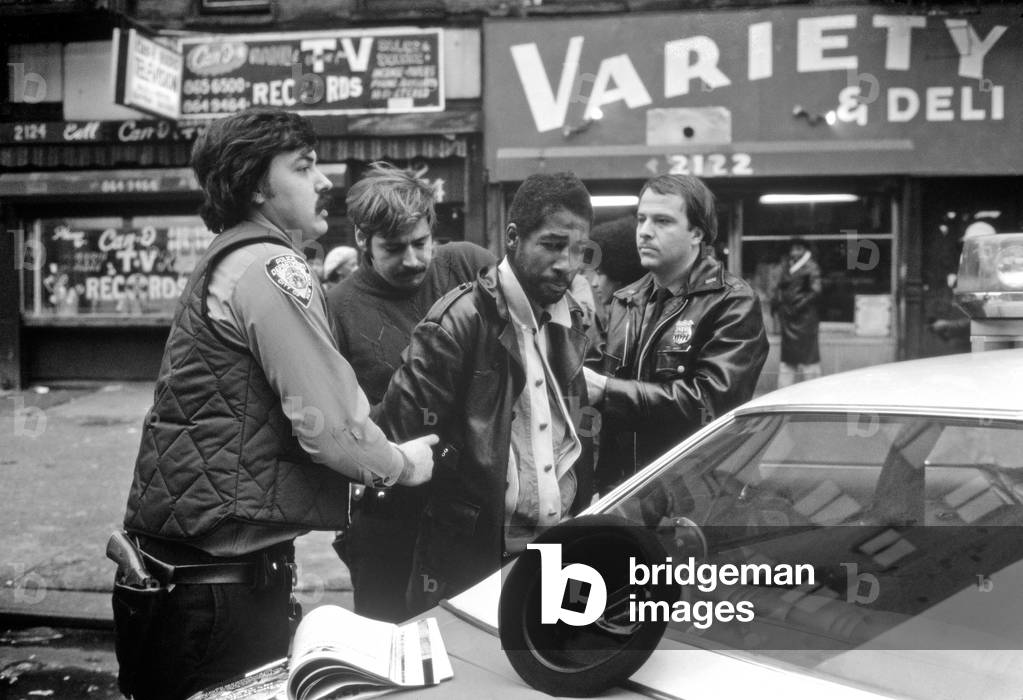 Arrest by New York City cops in Harlem on an African American, New York, USA, 1970s (b/w photo)