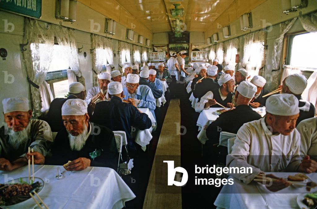 Chinese Muslim pilgrims in train dinning car from Yinchaun, Ningxia Autonomous Region to Lanzhou, Gansu province, China (photo)