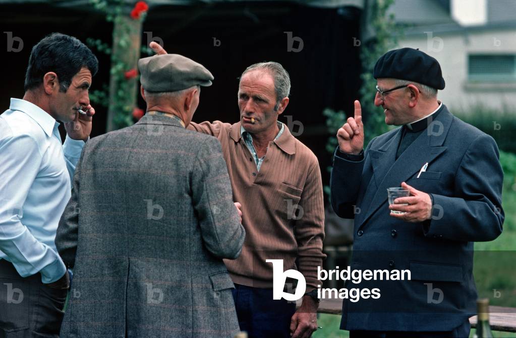 Local priest and villagers at Village St Clair Fete, Normandy, France (photo)