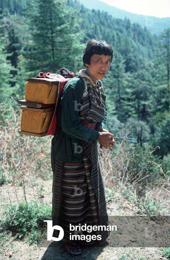 Pilgrim travellers carrying holy scriptures, Bhutan, Himalayas (photo)