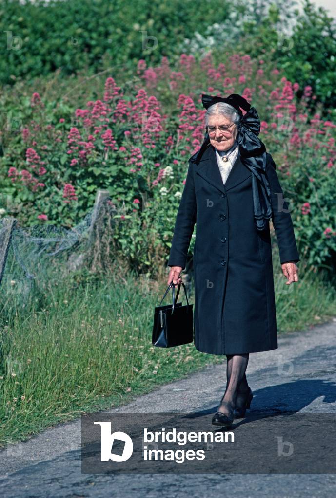 Breton lady on way to Sunday Mass, Island of Ushant, Brittany, France (photo)