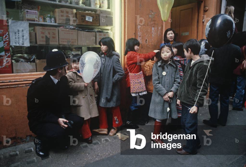 London policeman during Chinese New Year, Chinatown, Soho, London, UK, 1981 (photo)
