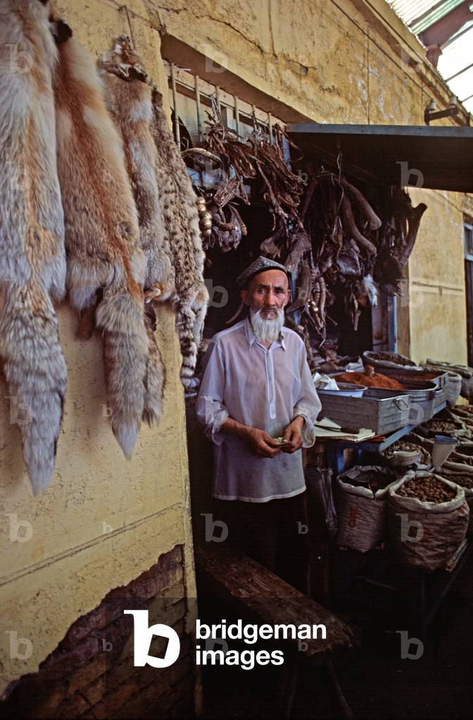 Trader in Illegal furs and animal bones used in Chinese medicine, Urumqi market, Xinjiang Province, China, 1985 (photo)