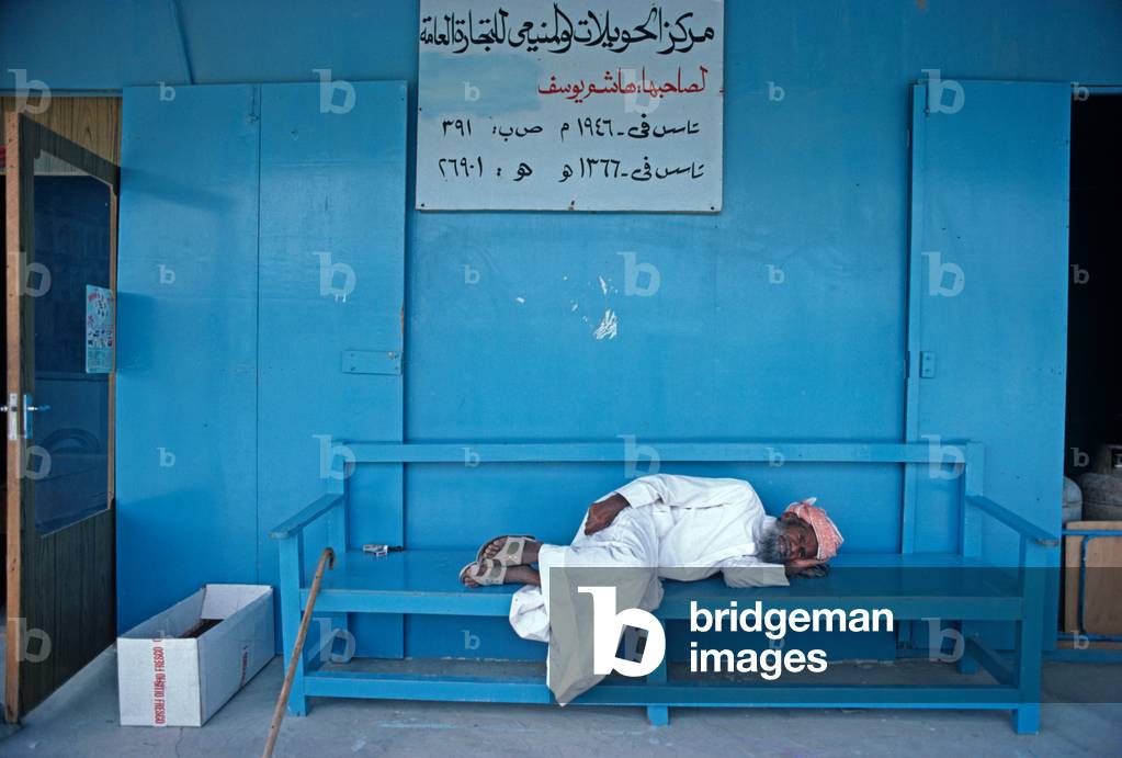 United Arab Emirate man sleeping midday in shade, Dubai, UAE