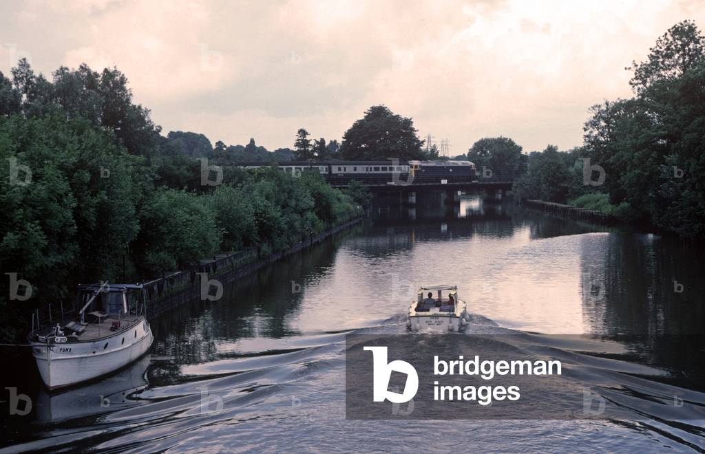 Diesel locomtive train over the Norfolk Broads on the Norwich to Sheringham line, Norfolk, England, 1982 (photograph)