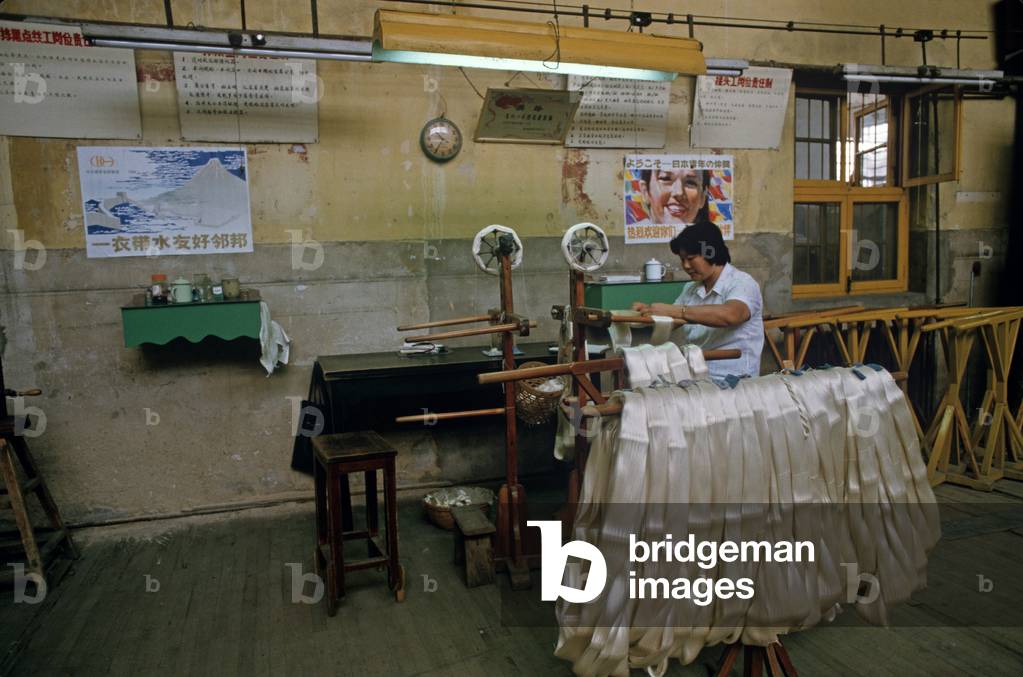 Silk after having been washed is wound onto spools during the Chinese silk process at the Hangzhou Silk Company factory, Hangzhou, Zhejiang Province, China (photo)