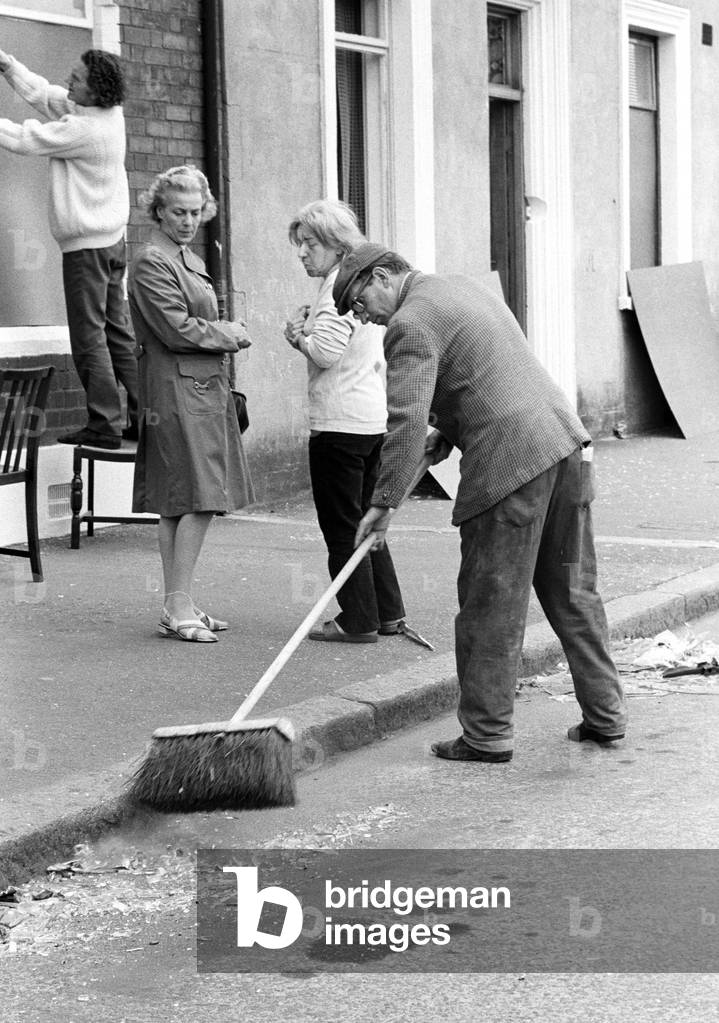 Clearing up after IRA bomb damage in the Shankill Loyalist area of Belfast in the early 70s, Northern Ireland during The Troubles, 1974 (b/w photo)