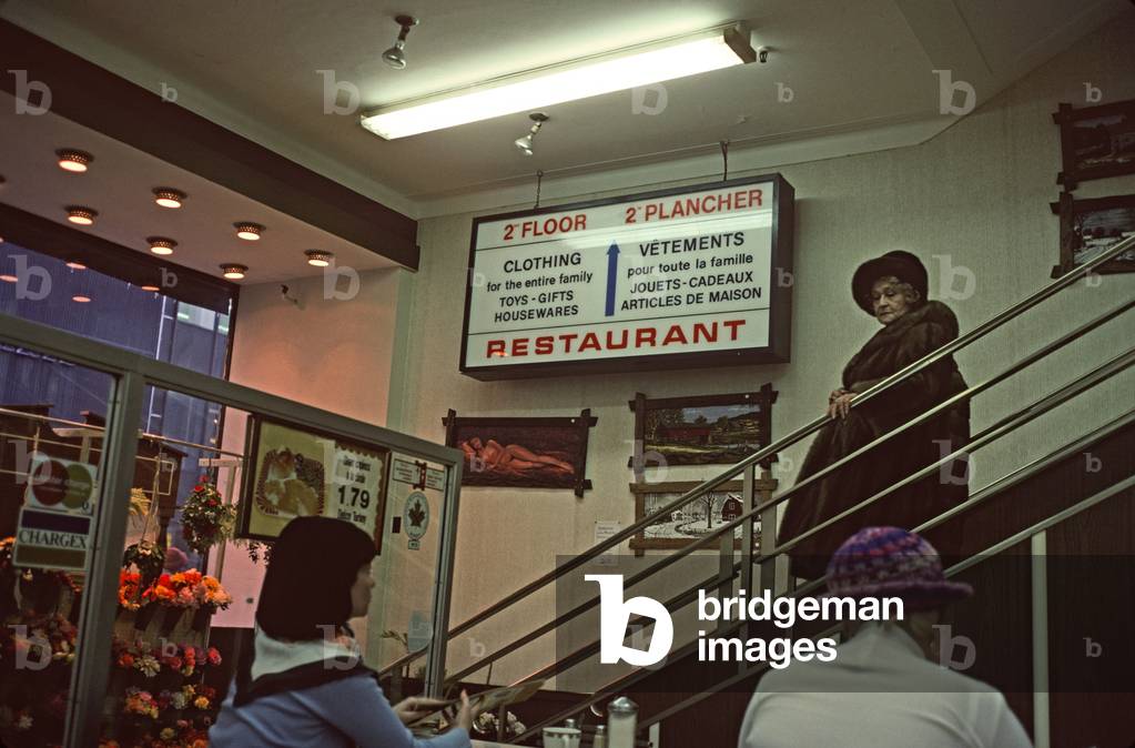 Woman in fur coat entering cafe in department store, Montreal, Quebec Province, Canada (photo)