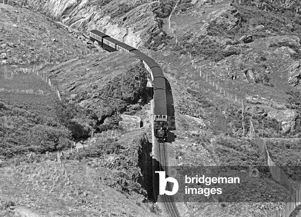 Steam locomotive Merddin Emrys on the Ffestiniog Railway running through Blaenau Ffestiniog slate mines, Gwynedd, North Wales, 1990 (photo)