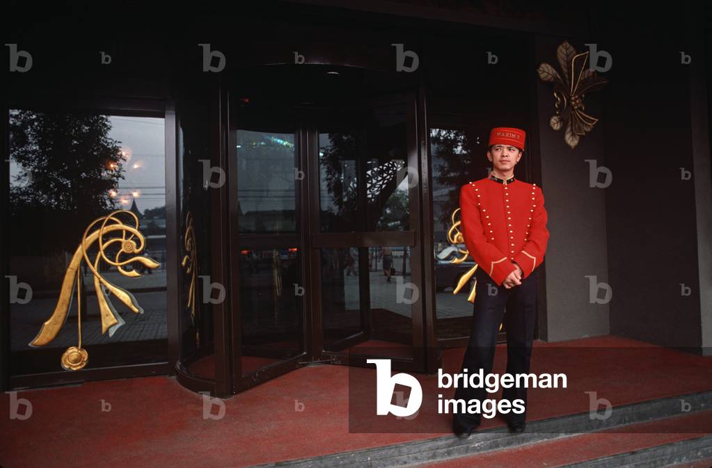 Chinese doorman infront of newly opened French restaurant Maxim's, Beijing, China (photo)