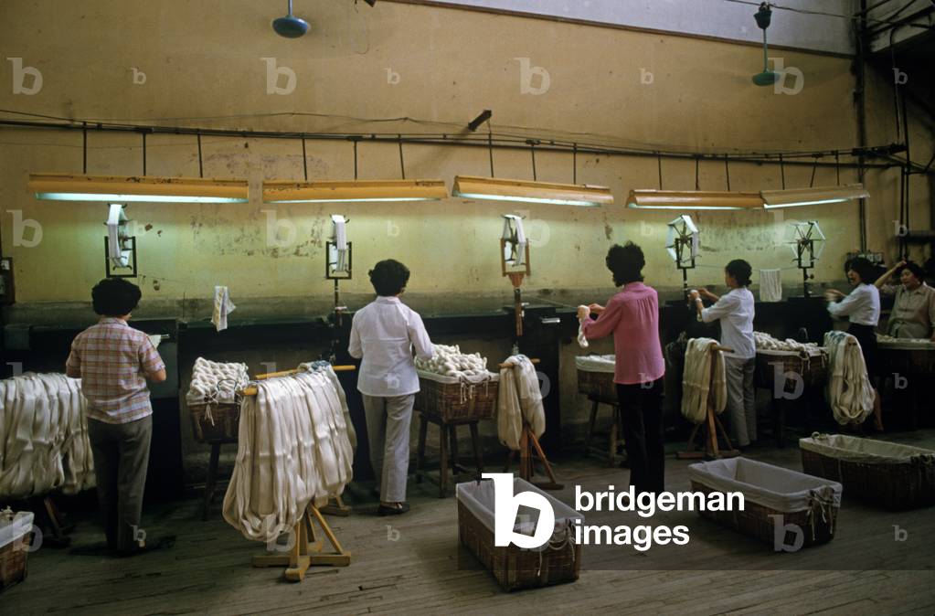 Silk after having been washed is wound onto spools during the Chinese silk process at the Hangzhou Silk Company factory, Hangzhou, Zhejiang Province, China (photo)