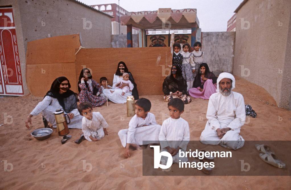Traditional United Arab Emirate family out side house in Dubai suburb, UAE