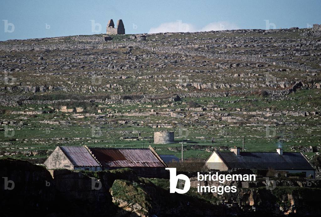 Coastal Village And Ruined Chuch On Inishmore, Aran Islands Off The Coast Of Galway, Ireland. Referred To By W. B. Yeats When He Suggested That Playwright John Millington Synge Visit Visit The Aran Islands.  (photo)
