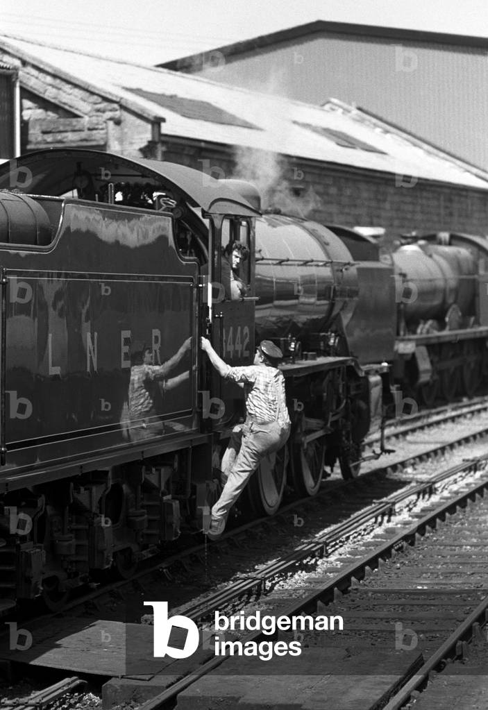 London & North Eastern Railway (LNER) 3442 The Great Marquess steam locomotive driver at Bridgenorth locomotive sheds on the Severn Valley Hertage Railway, Shropshire & Worcester, England, UK, 1989 (b/w photo)