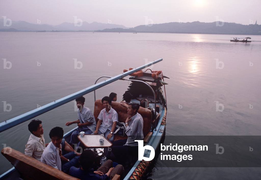 Chinese tourists settling down in tourist boat on West Lake, Hangzhou, Zhejiang Province, China (photo)