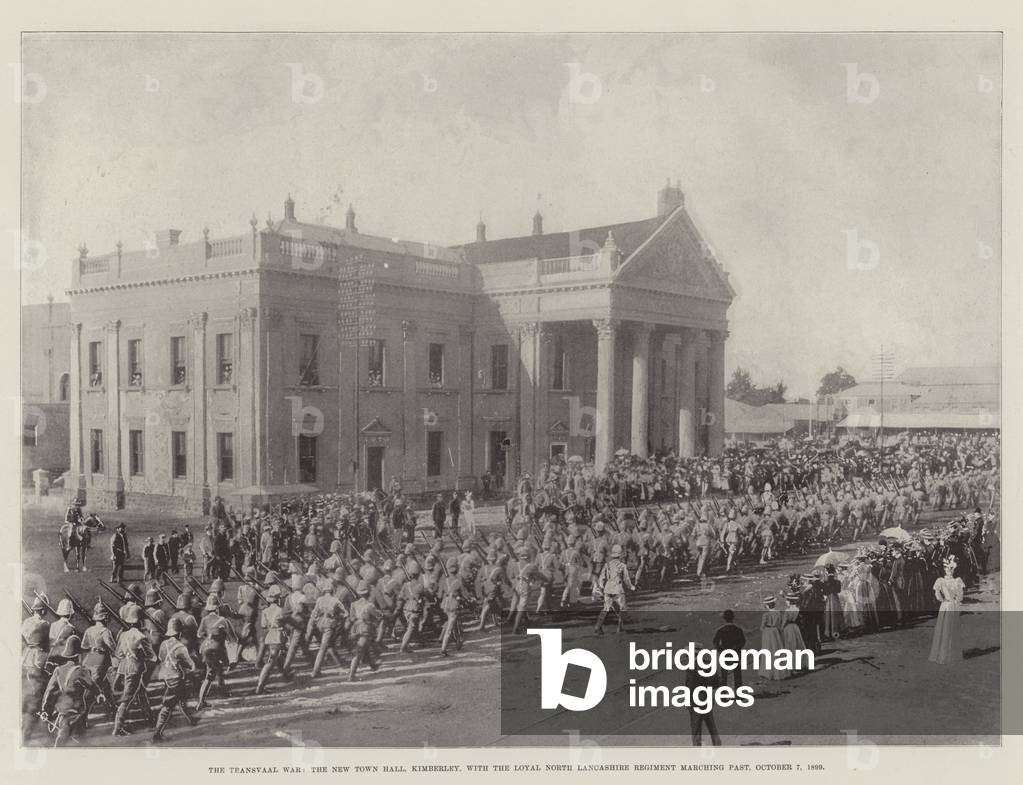 The Transvaal War, the New Town Hall, Kimberley, with the Loyal North Lancashire Regiment marching past, 7 October 1899 (b/w photo)