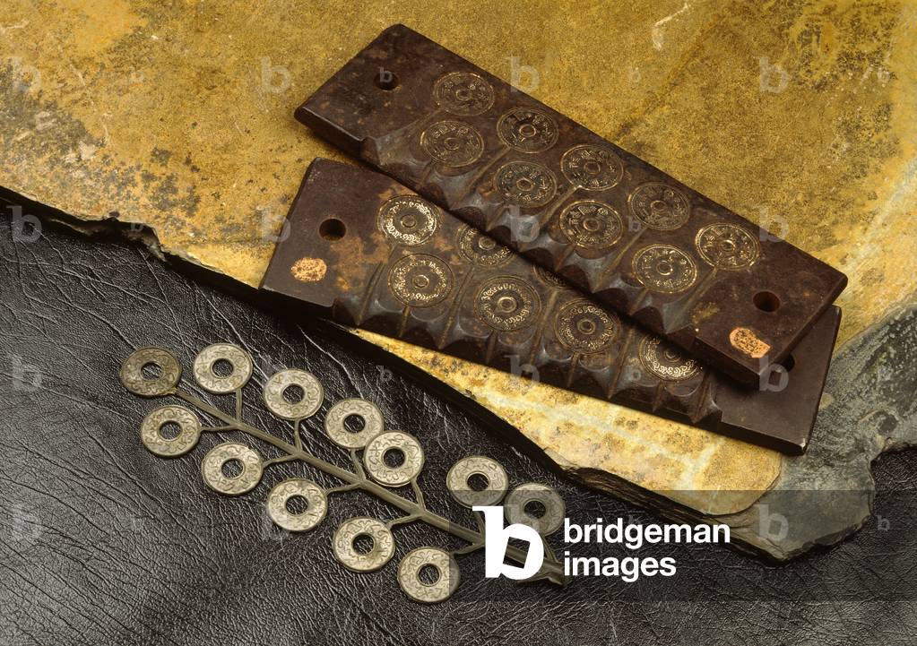 Freshly printed coins and a tool for printing and stamping money, southern Thailand (photo)