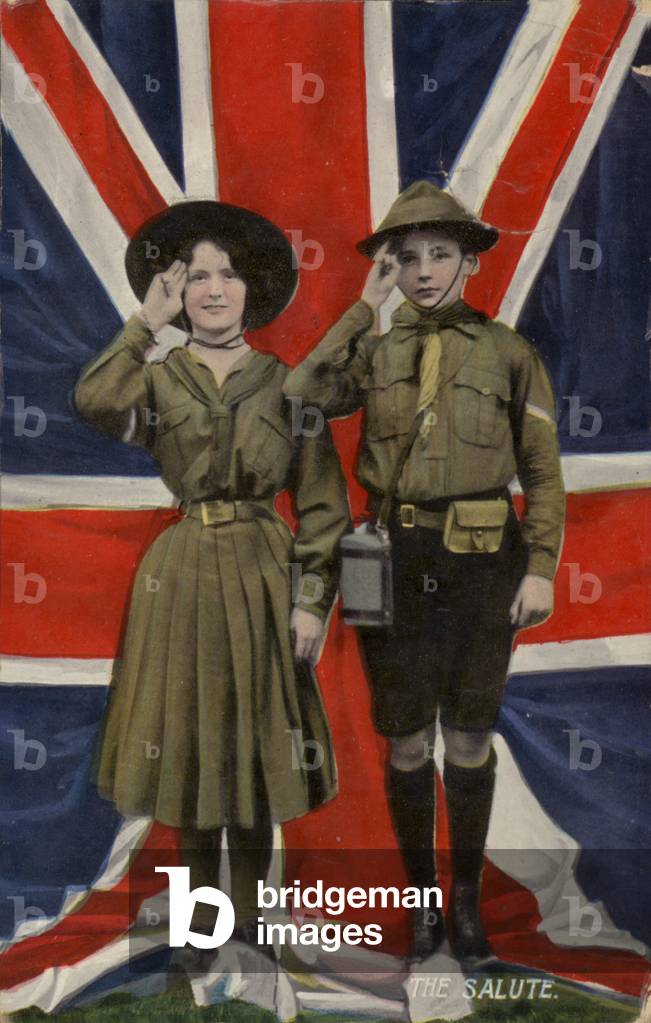 Girl guide and boy scout saluting in front of the union flag (photo)