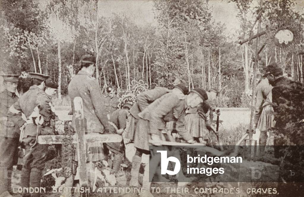 Soldiers of the London Scottish Regiment attending to their comrades' graves, World War I (b/w photo)