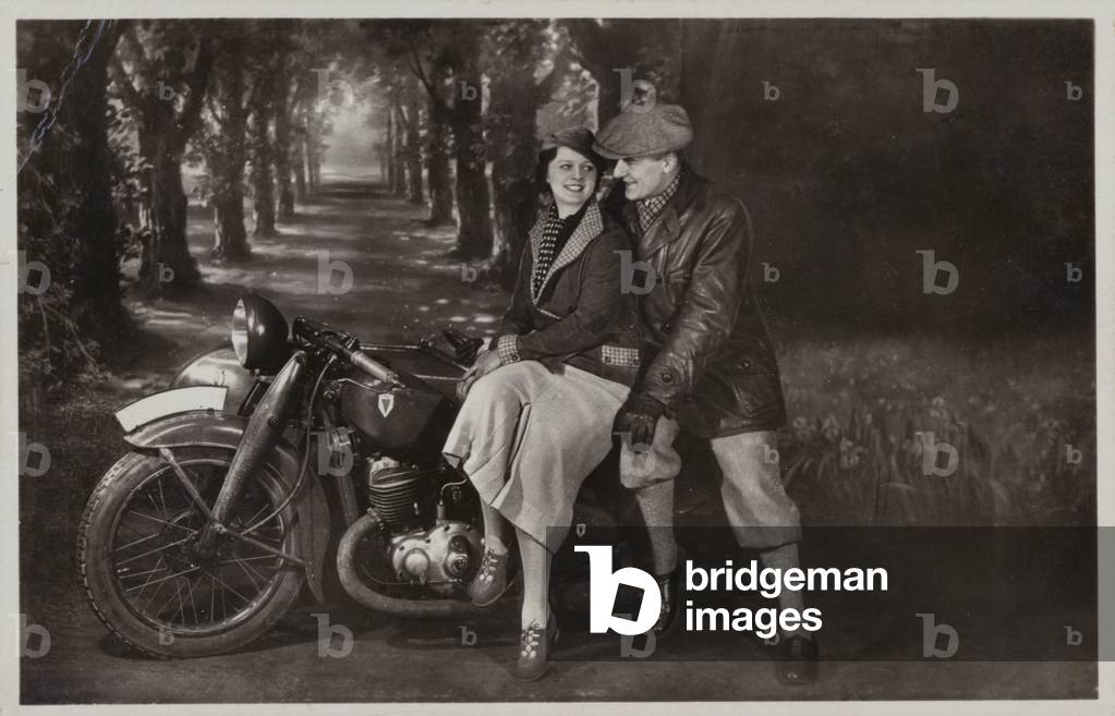 Couple with a motorcycle and sidecar (b/w photo)