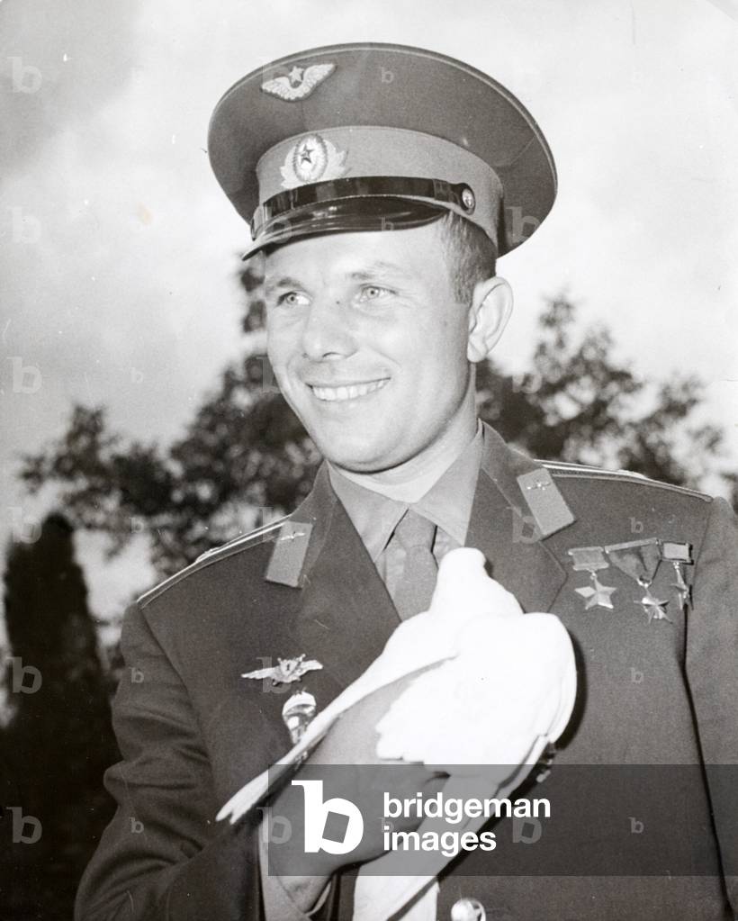 Soviet cosmonaut Yuri Gagarin, the first man in space,  holding a white dove, the symbol of peace (b/w photo)