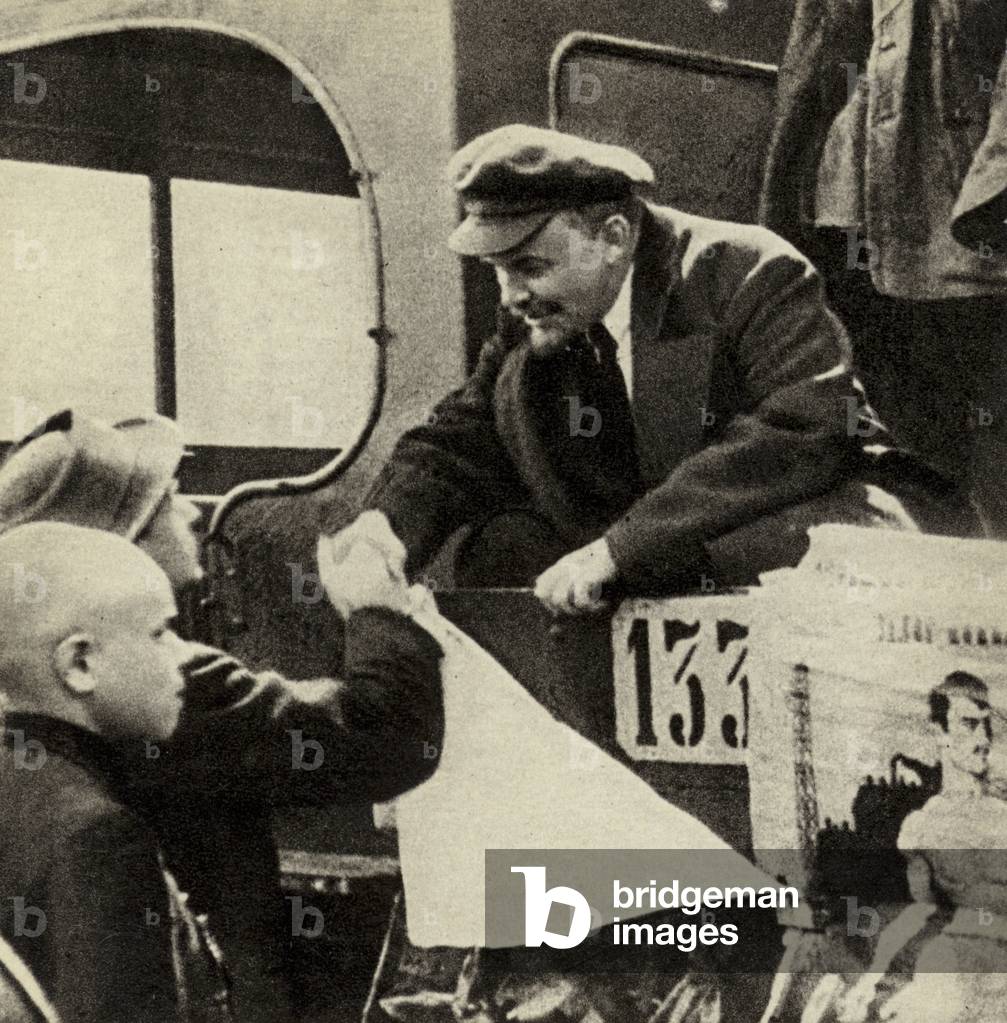 Lenin shakes hands with a participant in the parade of Vsevobuch detachments before leaving Red Square, Moscow, 25 May 1919 (b/w photo)