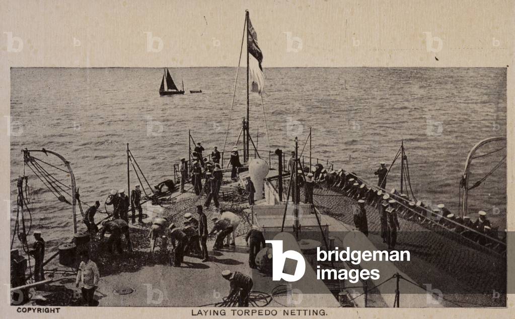 Laying torpedo netting on board a British warship (b/w photo)