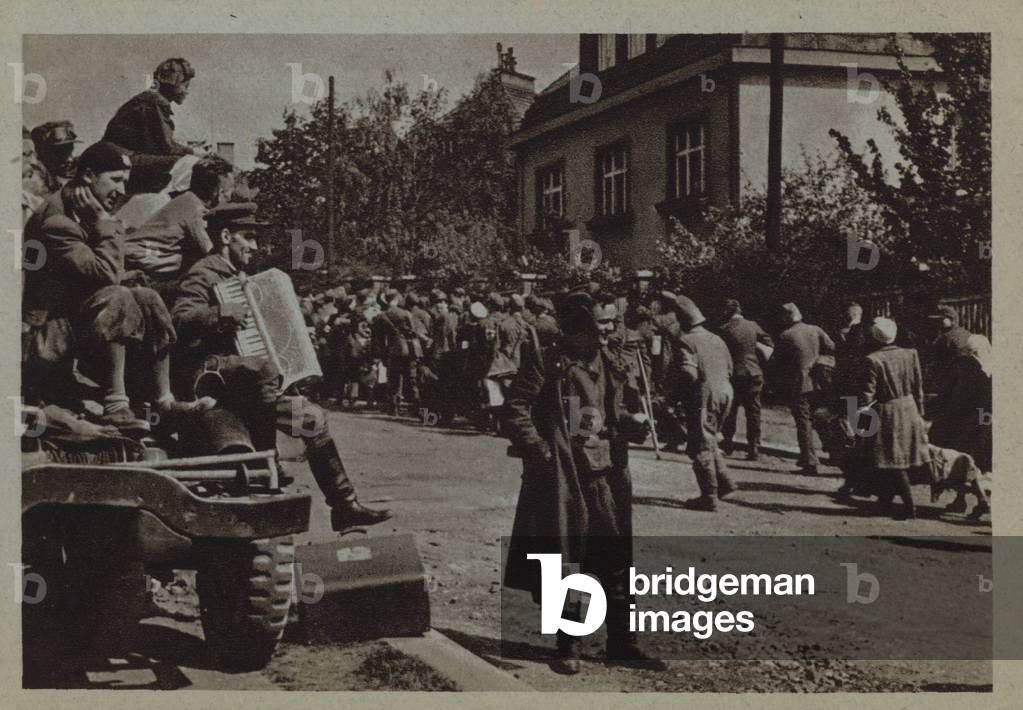 Russian soldiers watching a passing column of refugees, Eastern Europe, World War II (b/w photo)